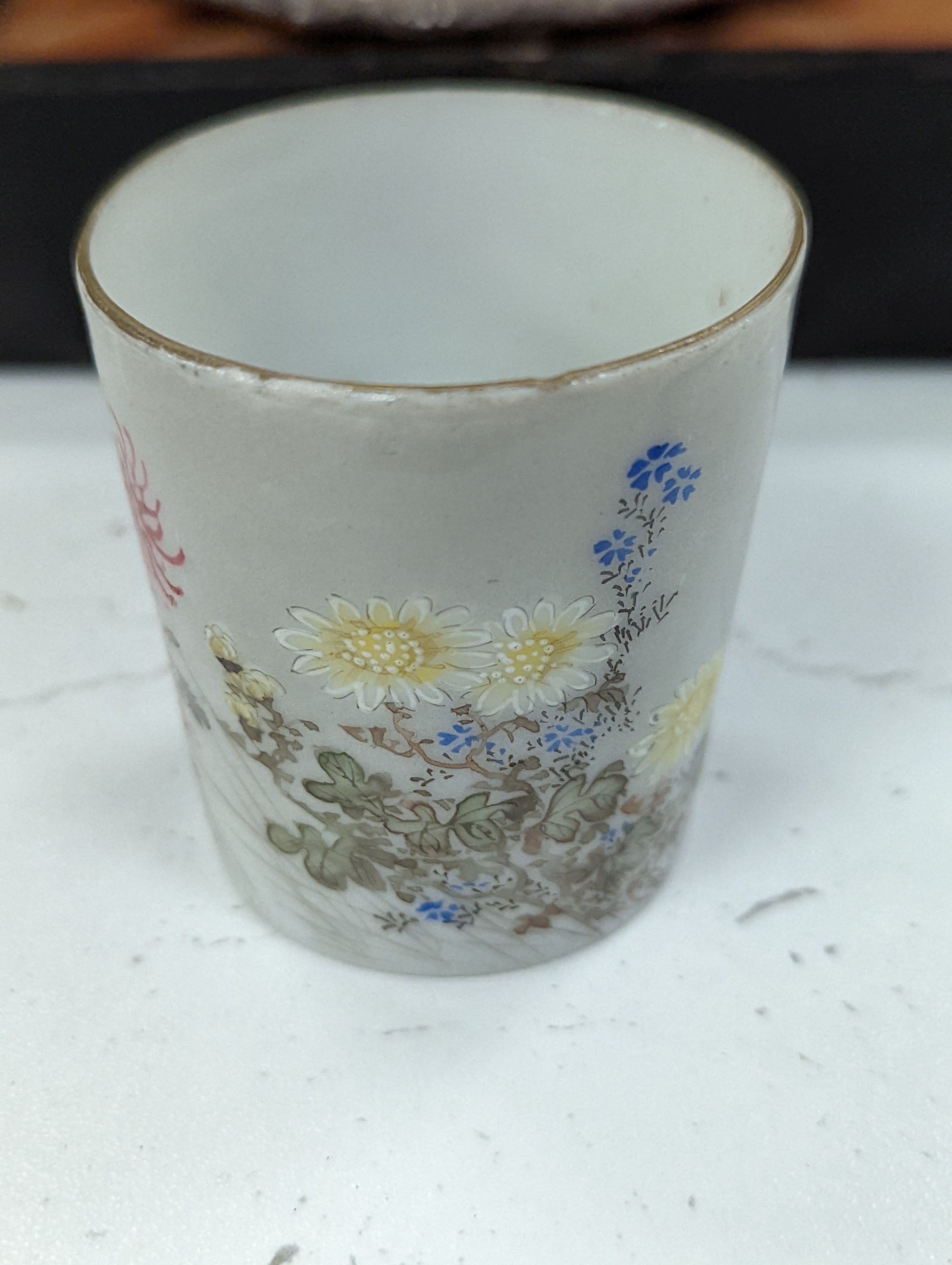 A cased Japanese white metal and eggshell porcelain six piece coffee set, maker’s mark only, case 39.5 cm wide